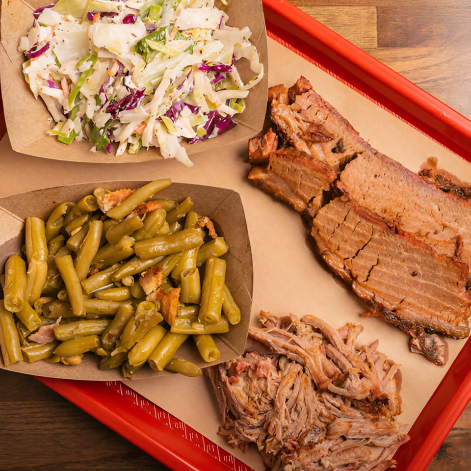 Double D's Southern BBQ platter with sliced brisket, pulled pork, coleslaw, and green beans.