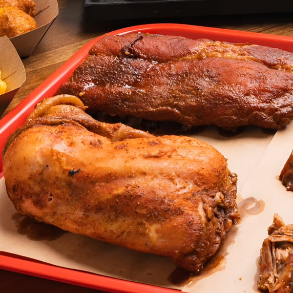 Double D's Southern BBQ platter with a whole smoked chicken and a rack of ribs.