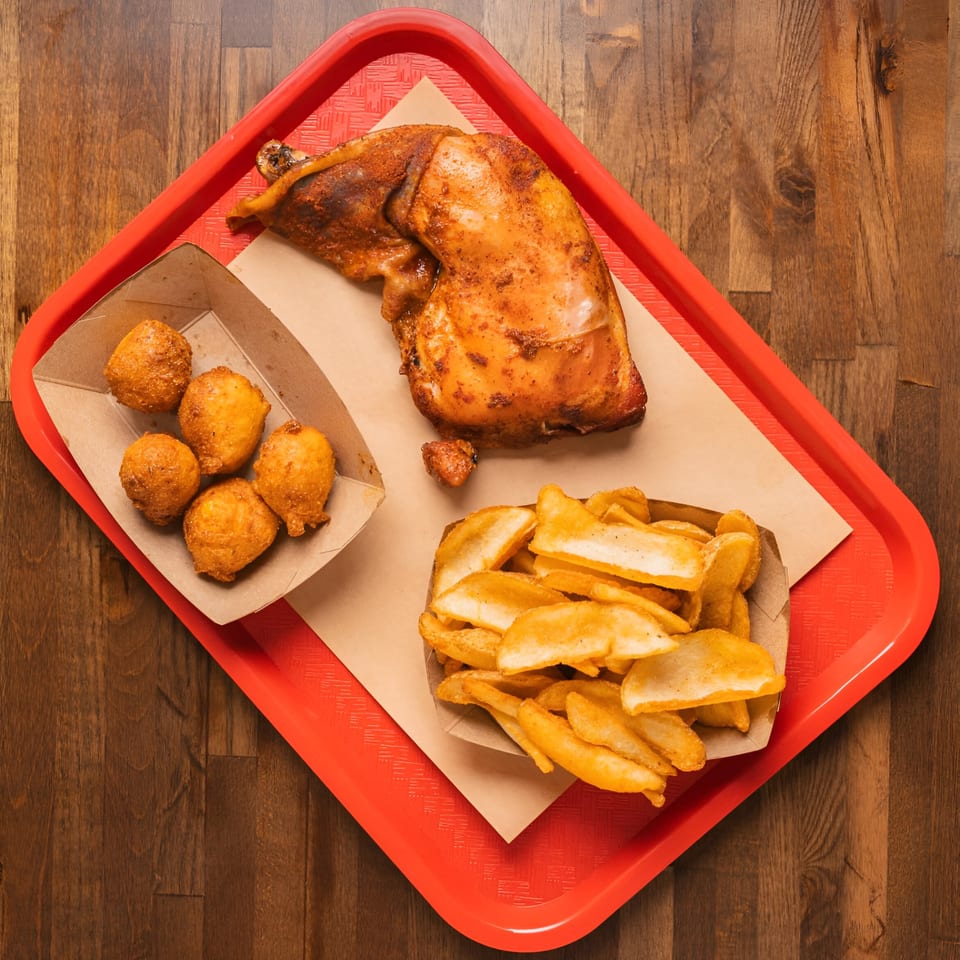 Double D's Southern BBQ meal with roasted chicken, hush puppies, and fries on a red tray.